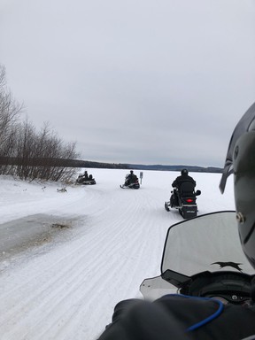 Snowmobiles ride the trails near the Auberge du Lac Taureau.