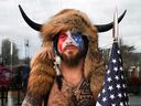Jacob Anthony Chansley, also known as Jake Angeli of Arizona, poses with his face painted in the colors of the United States flag as supporters of United States President Donald Trump gather in Washington, DC, on January 6. of 2021. 