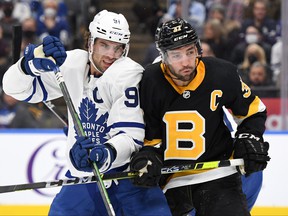 Toronto Maple Leafs forward John Tavares fights for position with Boston Bruins forward Patrice Bergeron in the second period at Scotiabank Arena in Toronto on November 6, 2021.