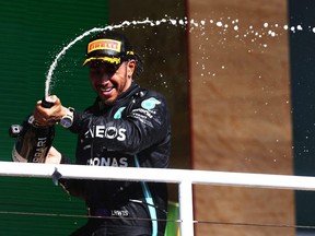 Race winner Lewis Hamilton celebrates on the podium during the Brazilian F1 Grand Prix at the Autodromo José Carlos Pace in Sao Paulo, Brazil, Sunday, Nov. 14, 2021.