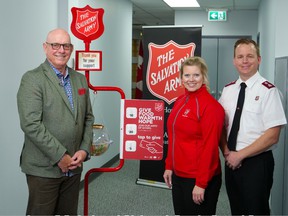 Patrick LaForge, former president of Edmonton Oilers leading this year's Salvation Army Red Kettle Campaign, with two Army aides, Major Elaine Locke and Major Jamie Locke.