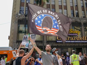 In this file photo, protesters for conspiracy theorist QAnon protest child trafficking on Hollywood Boulevard in Los Angeles on August 22, 2020.