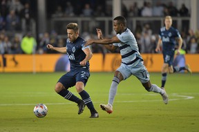 Vancouver Whitecaps defender Marcus Godinho (left) plays the ball against Sporting Kansas City midfielder Gadi Kinda in the second half of his first MLS playoff game at Children's Mercy Park.