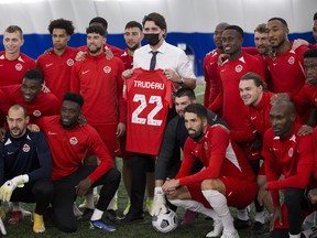 The Canadian men's soccer team poses for a photo with Prime Minister Justin Trudeau during practice at the Edmonton Soccer Dome on Monday, Nov. 15, 2021, in Edmonton.