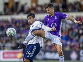 Kadin Chung (right) of Langford's Pacific FC vies for the ball with Vancouver Whitecaps forward Brian White during a Canadian championship game in Langford, near Victoria, this summer.  The owners of Pacific FC are behind the new Canadian Premier League franchise in the Lower Mainland, which will begin play in 2023.