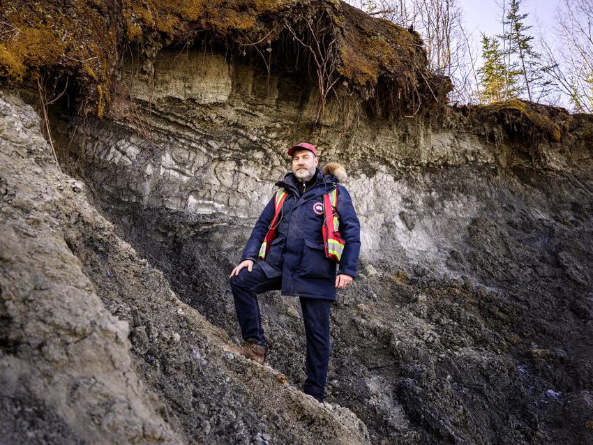 Fabrice Calmels, a professor of research in permafrost and geosciences at Yukon University, stands on the side of a permafrost fall in the Yukon in this photo from the May brochure.