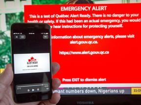 A smartphone and television receive visual and audio alerts to test Alert Ready, a national public alert system.