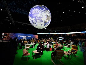 Delegates attend the UN Climate Summit COP26 in Glasgow.  Dependence on fossil fuels harms billions of vulnerable people living on the front lines of climate change, says Leehi Yona.