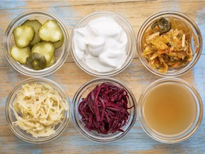Many fermented foods are sources of probiotics.  From top left: pickled gherkins, coconut milk yogurt, and kimchi.  From bottom left: sauerkraut, red beets, and apple cider vinegar.