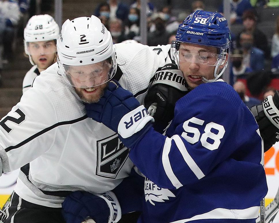 After three quick goals in his first season as Leaf, Michael Bunting, right, battling Alexander Edler of the Kings, has been knocked out despite landing on the top line.
