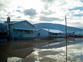Floodwaters blanket a neighborhood a day after heavy rains prompted the evacuation of the city of 7,000 in Merritt on Nov. 16.