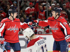Capitals defender John Carlson, right, celebrates his power play goal with center Evgeny Kuznetsov during the first period Wednesday night as the Canadiens' Cédric Paquette skates away.