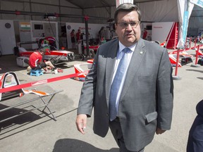 Denis Coderre walks through the paddock at the Montreal Formula ePrix electric car race in Montreal on Friday, July 28, 2017.