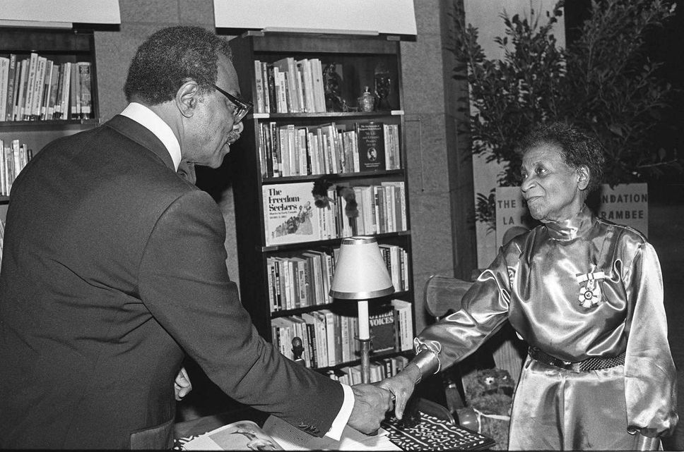 The Ontario Lieutenant congratulates Dr. Carrie Best, a prominent rights activist.  Governor Lincoln Alexander during a ceremony in Ottawa in 1988.