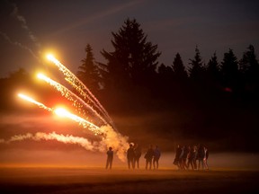 A group of young people shoot fireworks on Halloween night 2020 in Vancouver.  The consumer ban on the sale and use of fireworks went into effect the next day.