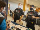 Windsor Police Sgt.  Andy Drouillard, left, and Const.  Sean Patterson speak to shoppers outside the food court at Devonshire Mall as part of Crime Prevention Week, Tuesday, Nov.9, 2021.