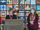 Patricia Savage, left, and Rebecca Rudman, co-founders of Windsor Essex Sewing Force, discuss the community quilt created by the Windsor Essex Sewing Force and displayed in the lobby of Windsor City Hall on Thursday, October 28, 2021.