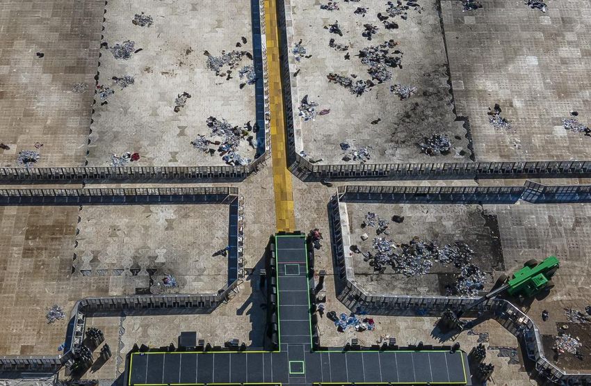 The Astroworld main stage where Travis Scott performed Friday night, where a growing crowd killed eight people, is littered with debris from the concert, in a parking lot at the NRG Center Monday in Houston.
