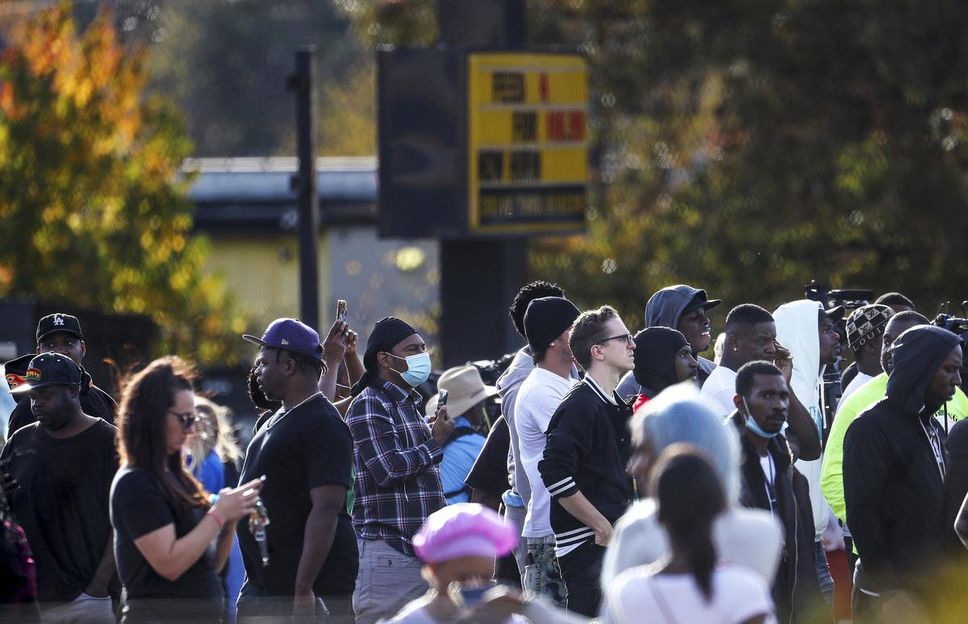 A crowd gathered at the scene where rapper Young Dolph was killed in a cookie shop in Memphis, Tennessee, on November 17, 2021. Young Dolph, widely admired in the hip-hop community for his authenticity and fierce independence, was shot and killed while inside the store.