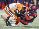 Bryan Burnham of BC Lions is brought down by Patrick Levels of Montreal Alouettes during the second half in Montreal at Spet.  February 18, 2021.