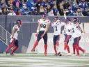 Montreal Alouettes defensive end Jamal Davis (99) celebrates with his teammates after recovering a fumble and returning it 19 yards for his first professional touchdown during the first quarter against the Blue Bombers in Winnipeg on November 6, 2021.