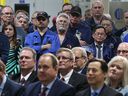 Workers and dignitaries at Ford's Essex Motor Plant in Windsor listen at a press conference with company executives and government officials on March 30, 2017.