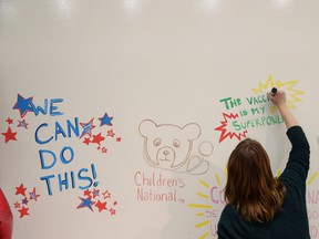 A wall of vaccine superheroes is decorated at a COVID-19 vaccination clinic for children in Washington.
