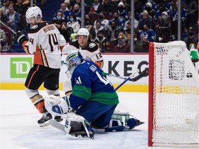 Anaheim Ducks' Cam Fowler, unseen, scores against Vancouver Canucks goalkeeper Jaroslav Halak (41) of Slovakia, while Adam Henrique (14) and Sonny Milano (12) of Anaheim watch during the first period at Rogers Arena on Tuesday.