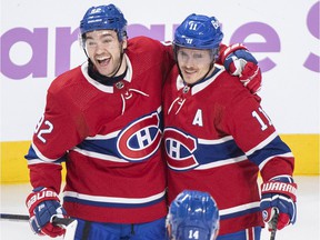 Brendan Gallagher (11) of the Canadiens celebrates with teammate Jonathan Drouin (92) after scoring against the Nashville Predators in Montreal on Saturday, Nov. 20, 2021.