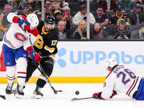 Nick Foligno (17) of the Bruins and Ben Chiarot (8) of the Canadiens battle for the puck during the first period at TD Garden in Boston on Sunday, Nov. 14, 2021.