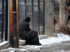 A homeless man sits in an inner-city alley in Edmonton.  File photo.
