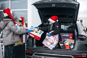 Jonathan (Bear) Yeung, 11, organizes donated toys that he gave to BC Children's Hospital in 2020. He's collecting donations again this year.  Source: Brochure photo