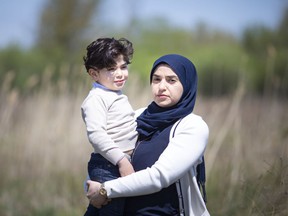 Khawla Khalifa, who says her husband kidnapped two of her children in 2019 and brought them to Lebanon, is pictured with her youngest son, Zein Zeidan, 4, next to their home in South Windsor on Saturday, May 1. of 2021.