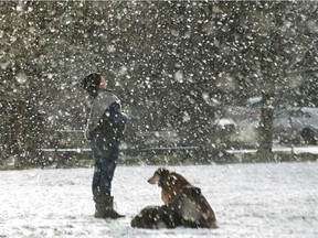 Funen Oakes enjoys the snow with her dogs Cedar and Maxine in Vancouver, BC, on February 8, 2021 during a cold snap.
