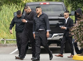 Allie Grewal of Friends of Hells Angels, also known as Ali Grewal, attends his funeral in Delta, on August 16, 2019. Accused murderer Tyrel Nguyen Quenelle (right, with the sides of his head shaved) attends the funeral of the murdered Hells Angel Supply 