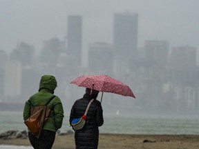Walkers in the rain along Vancouver's Spanish banks on November 7, 2021.