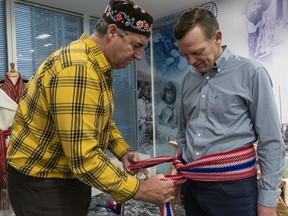 Métis Nation director Louis De Jaeger, left, introduces Darrell Fox, Terry Fox's brother, is a traditional Métis band.