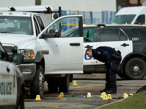 An ASIRT investigator reviews the scene of a 2019 shooting involving Edmonton police near 100 Street and 105A Avenue.  The agency director says ASIRT is struggling with an ever-increasing file count, along with funding and staffing issues.