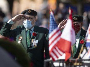 Honoring comrades.  Robert Goyeau, 87, a Korean peacekeeping veteran, salutes at the foot of the cenotaph during the laying of wreaths at the Remembrance Day ceremony in downtown Windsor on Thursday, Nov. 11, 2021.