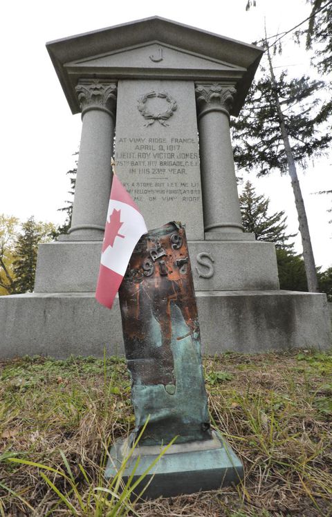 The stump of a copper clad Vimy Ridge memorial cross stands in front of the Lieutenant's memorial.  Roy Victor Jones at Park Lawn Cemetery.
