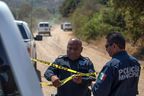 Police officers hold up a police cordon at the place where two young American children were found dead, in Rosarito, Baja California state, Mexico, on August 9, 2021. Photo taken on August 9, 2021.