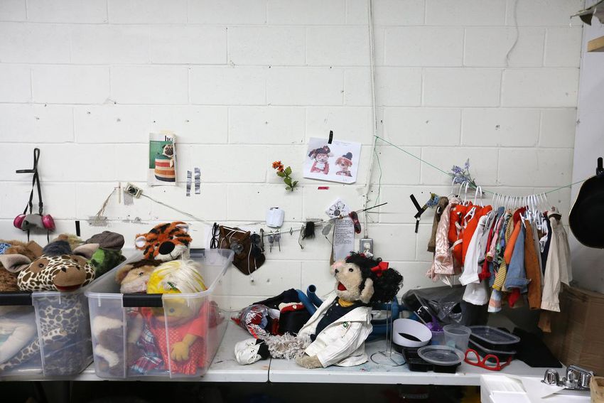 Puppets, clothing, and accessories fill the Lees' workspace.