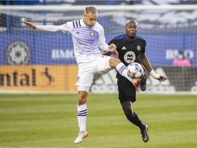 CF Montréal's Kamal Miller, right, challenges Orlando City's Silvester van der Water during the first half of MLS soccer action in Montreal on Sunday, Nov. 7, 2021.