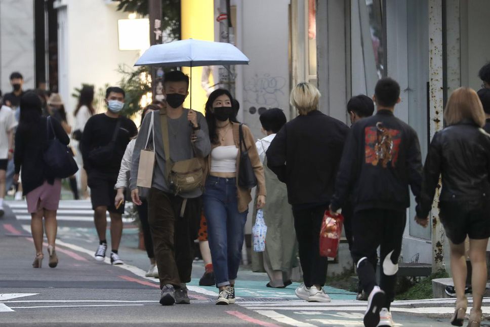 People wear face masks to protect themselves against the spread of the coronavirus in a popular shopping district in Taipei, Taiwan, last month.  Beijing is increasingly watching any foreign involvement with Taiwan, observers say.