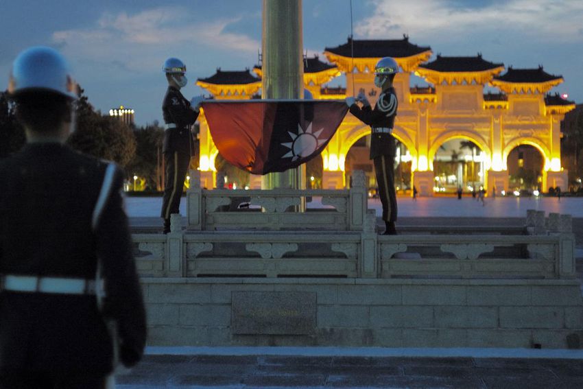 This September photograph shows honor guards folding the Taiwanese flag during a flag-lowering ceremony at the Chiang Kai-shek Memorial Hall in Taipei.
