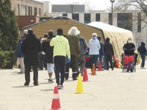 The Toronto Daily Bread Food Bank lineup on New Toronto St. in Etobicoke on April 8, 2020. The TDBFB installed an inflatable medical tent outside of its premises along with a conveyor belt to deliver food to its customers.