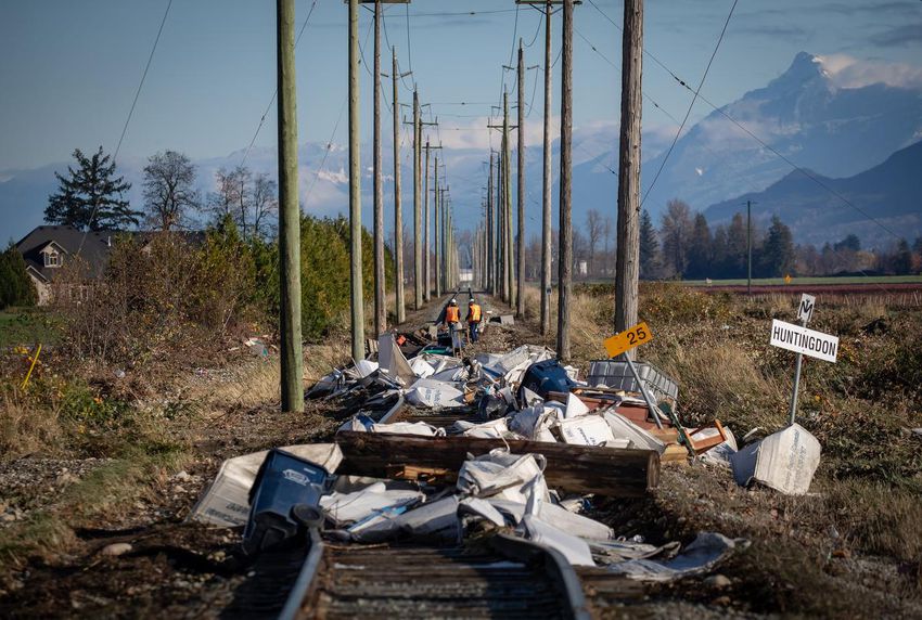 Employees of the Southern Railway of British Columbia (SRY Rail Link) inspect a section of rail lines that are washed out in numerous locations and covered with flood debris after the water receded in Abbotsford, BC