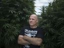 Marijuana activist and medical marijuana licensee Leo Lucier is seen Wednesday, Sept. 19, 2018, in the backyard of a friend's home in Amherstburg, Ontario, where he has been growing giant marijuana plants.