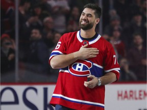 Super Bowl-winning Kansas City Chiefs offensive lineman Laurent Duvernay-Tardif touches his heart as he receives a standing ovation before the Montreal Canadiens game against the Arizona Coyotes in Montreal on February 10, 2020.