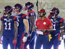 Montreal Alouettes head coach Khari Jones stands on the sidelines with some of his players during the Canadian Soccer League game against the Hamilton Tiger Cats in Montreal on Friday, August 27, 2021.